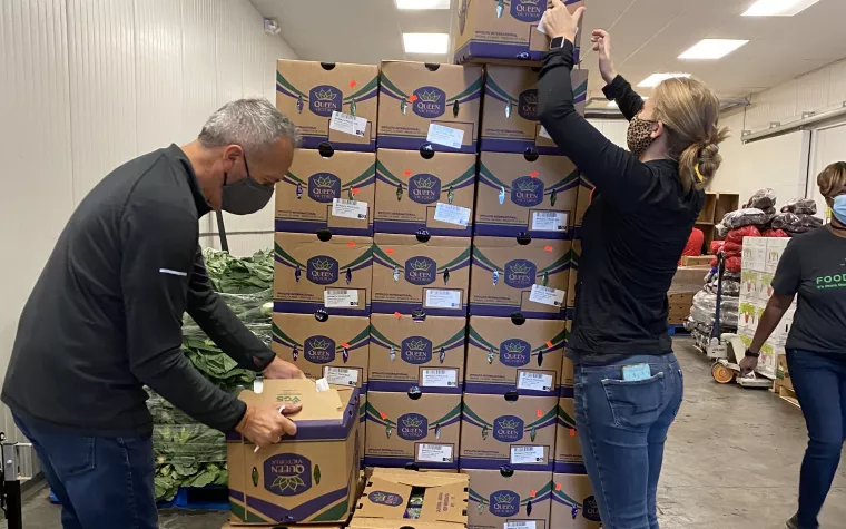 People stacking boxes of food