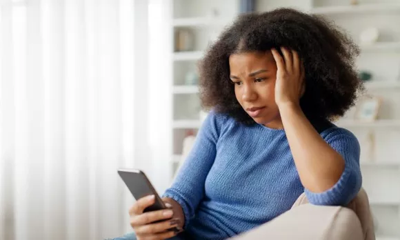 A concerned patient/woman looking at her phone.